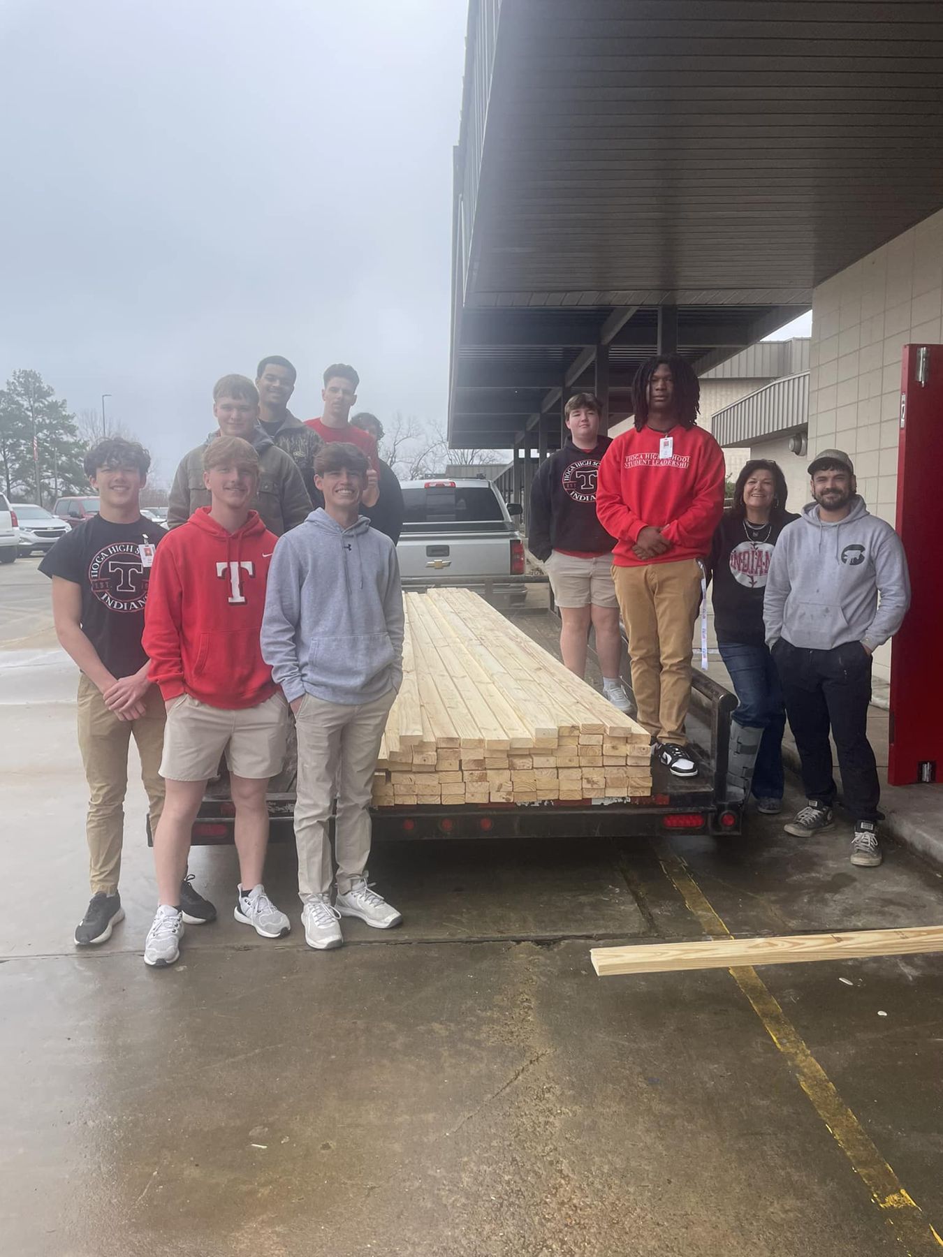 Students with a delivery of lumber